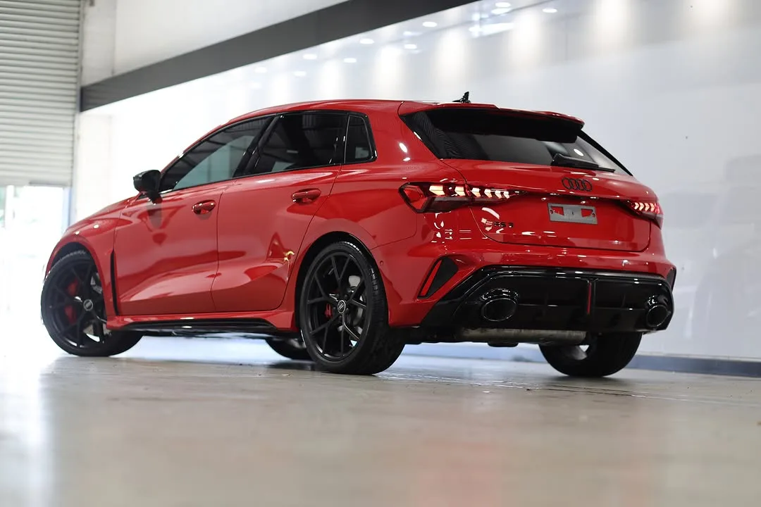 The rear of the Audi RS3, its bumper protected with clear film