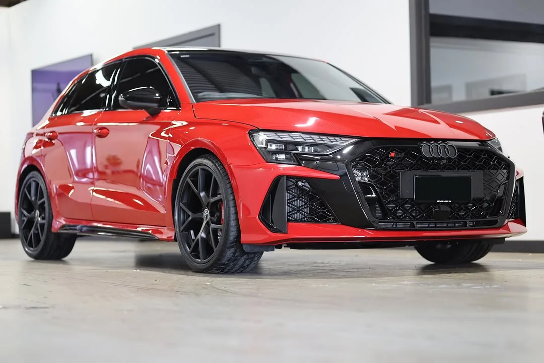 A red Audi RS3 in the studio