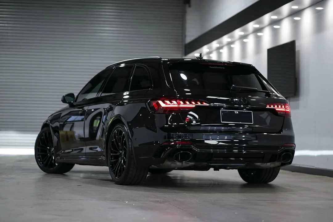 A black Audi RS4 Avant with ceramic window tint