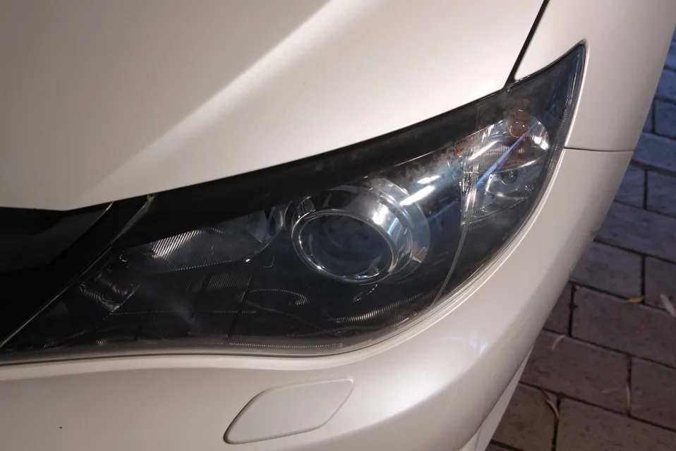 A hazy Subaru Impreza headlight before restoration