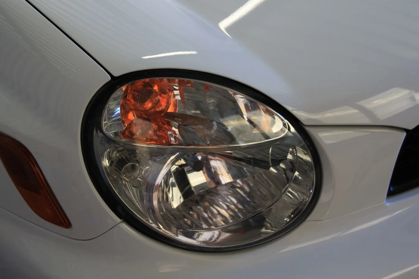 The same Subaru WRX headlight, clear after restoration