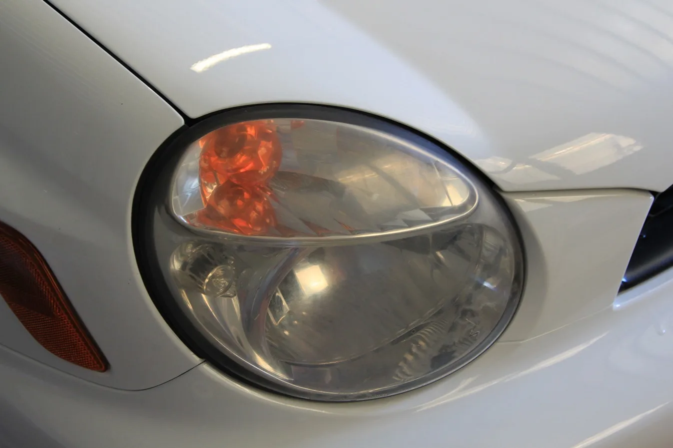 A cloudy, oxidised Subaru WRX headlight before restoration