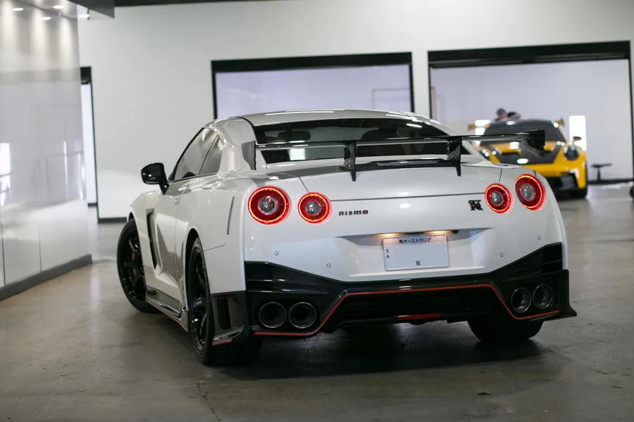 A white Nissan GT-R Nismo from behind in the studio