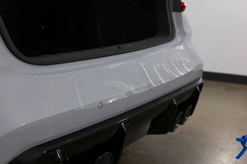 Freshly fitted protection film on a BMW M3 rear bumper